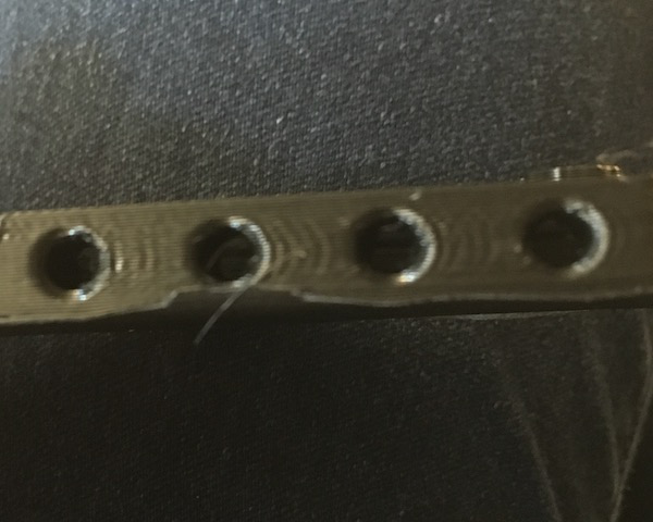 There's some mild ringing about the screw holes (no threads were printed). Delamination may occur when holes are tapped.